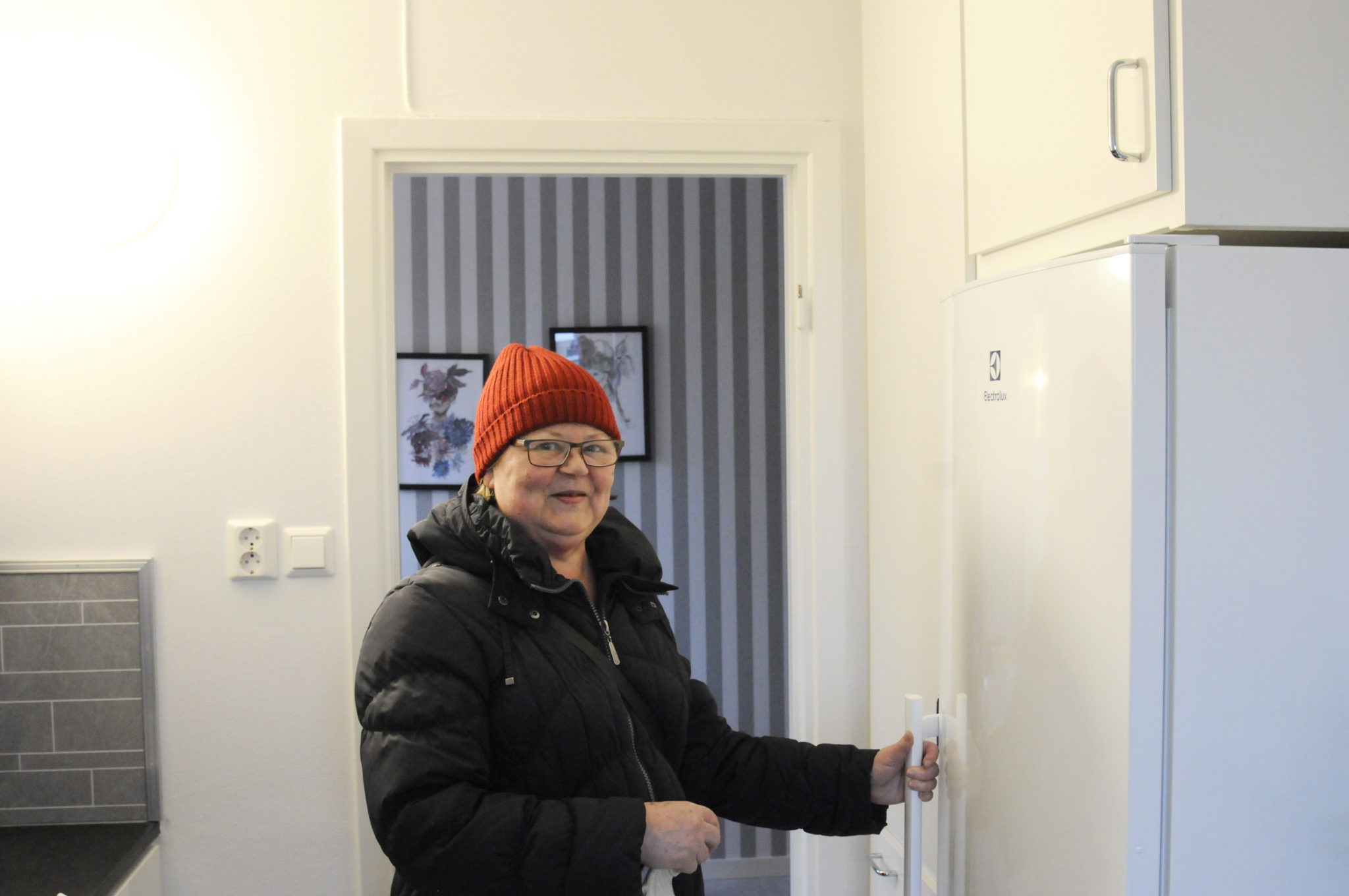 Kvinna vid kylskåp.